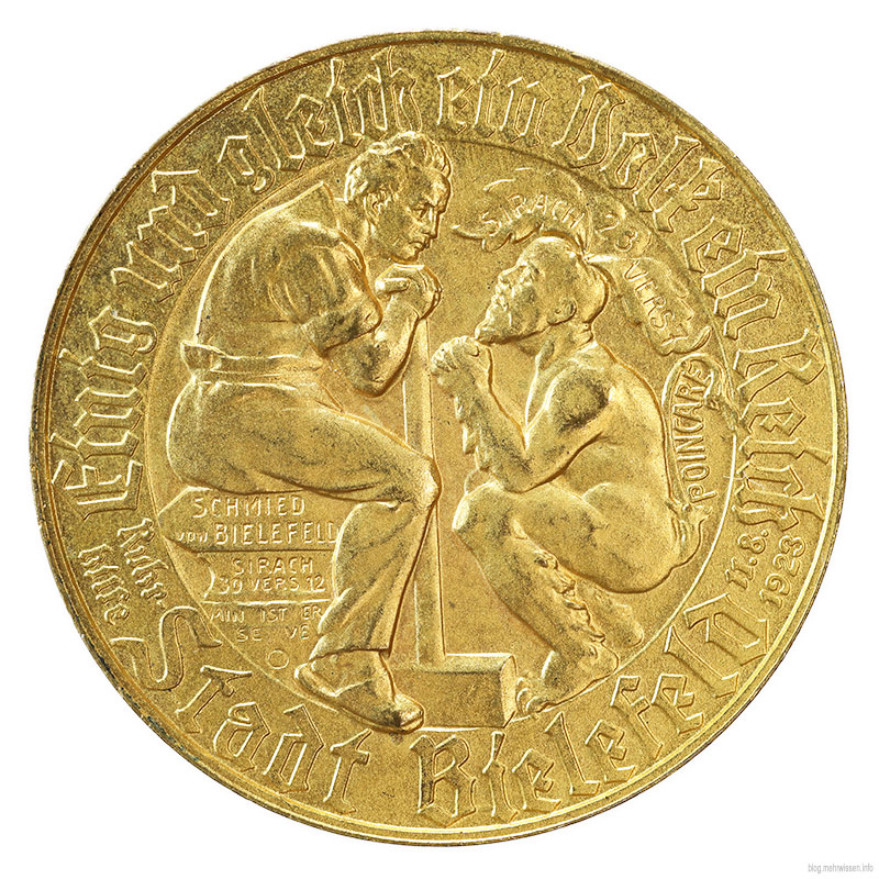 Rückansicht der Medaille, Hauptmotiv: Carl Severing als Schmied von Bielefeld und Raymond Pointcare als Teufel